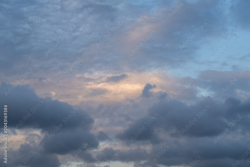 Obraz premium Dark blue and gray clouds at sunset.