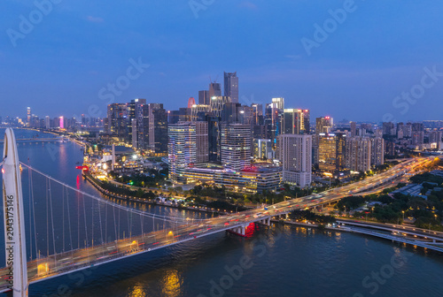 Aerial View of Guangzhou Skyline at Dusk with Illuminated Buildings and Bridge