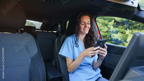 Photography Medical professional using smartphone inside car cabin