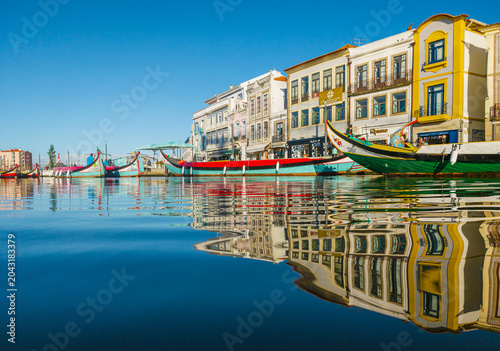 Bild auf Leinwand Traditional moliceiro boats docked along the central canal in Aveiro, Portugal