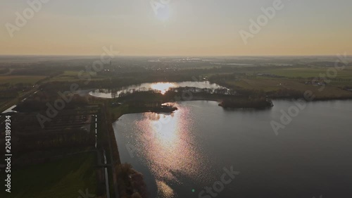 Aerial approach over Engelenmeer lake and Dutch countryside at Golden Hour