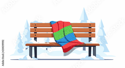 A cozy, multicolored blanket is draped over a wooden bench in a snowy winter park