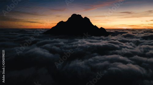 Tableau sur toile Mountain peak rising above a sea of clouds at sunset or sunrise.