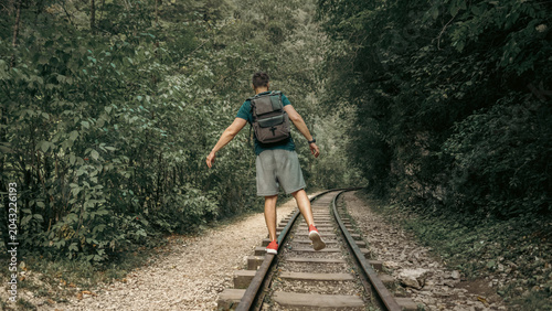 old railway without a train and without people in the forest in the mountains