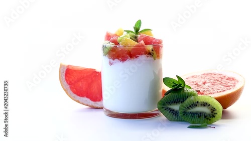healthy yogurt dessert with kiwi orange and grapefruit on clean background