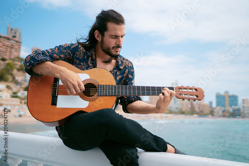 Spanish Guitar Performance with Passion and Scenic Seaside City View