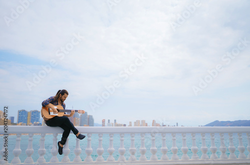 Flamenco Guitarist Performing Outdoors with Copy Space and City Skyline