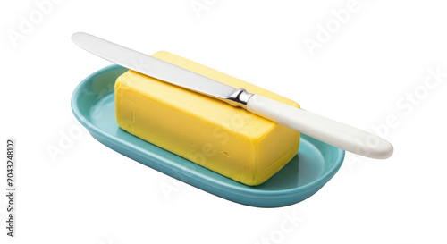 A block of fresh yellow butter sitting on a small teal ceramic dish with a whitehandled butter knife resting on top, isolated on transparent background