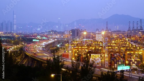 Cargo terminal port timelapse in Hong Kong of China. Busy cargo container loading activities. Rush hour road and traffic. Beautiful vibrant city vibe.