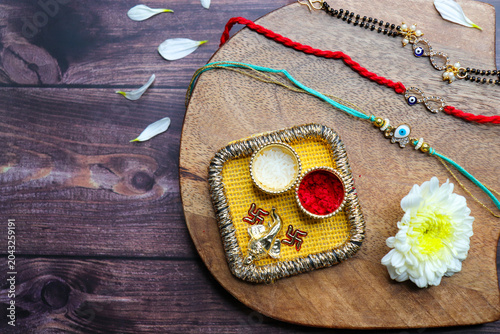 Indian festival Raksha bandhan. Rakhi thali with diya, flowers and tilak with sweet boondi or bundi. Puja thali for rakhi festival with roli chawal. copy space. also known as Narali Purnima. 