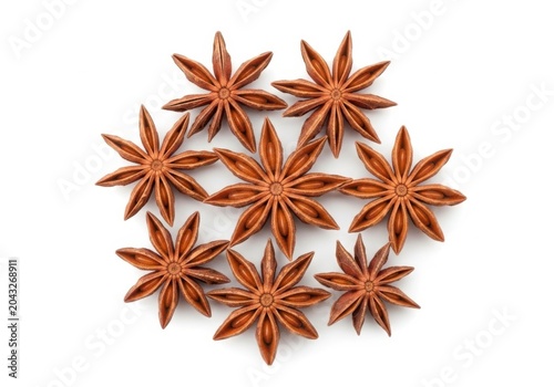 Whole star anise spices arranged closely together isolated on white background