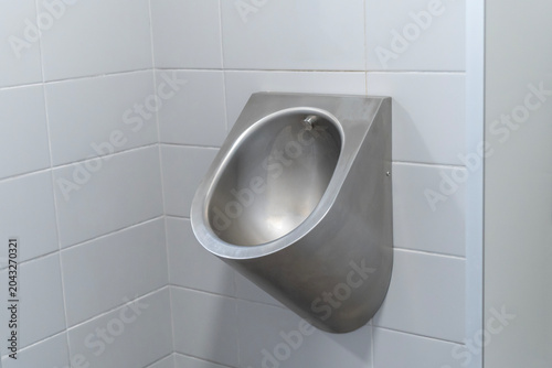 Urinals in a gray tiled public toilet