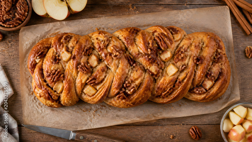 Braided Sweet Bread Loaf with Nuts on Parchment Paper, Rustic Bakery Food Close Up