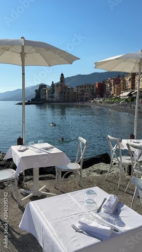 Enjoying lunch at a cafe by the sea in Camogli, Italy on a sunny day