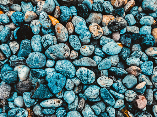 Smooth pebbles and stones on a beach creating a natural rock texture background