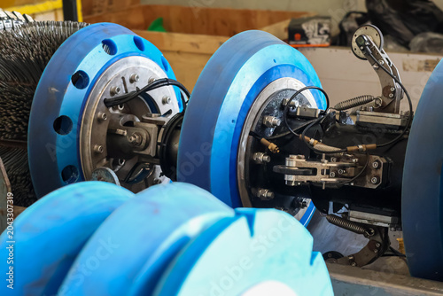 Photography Industrial smart pigging tool with blue polyurethane cups and sensors for pipeline inspection and cleaning in a workshop