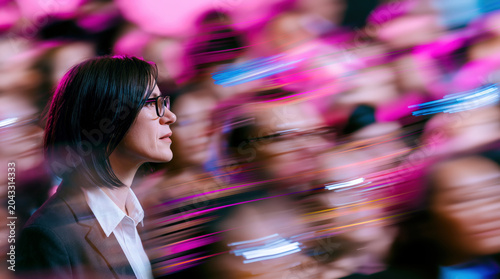 Focused Businesswoman Looking Ahead Through Magenta Abstract Corporate Blur