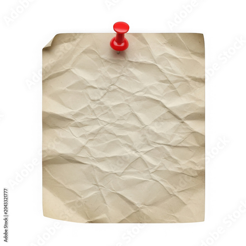 Red pushpin on crumpled paper note
