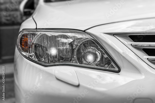 Canvas Print Modern white car headlight focusing on the detailed design and gleaming glass elements