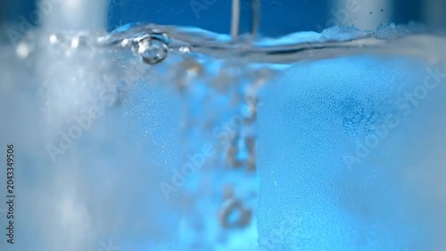 Water Pouring into Glass with Bubbles