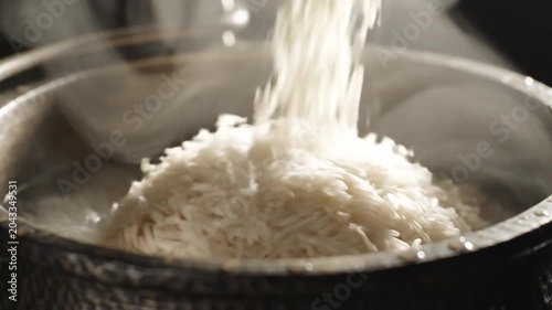 White Rice Poured Into Steaming Pot
