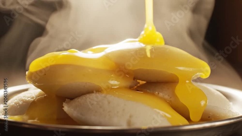 Yellow Sauce Poured Over White Dessert Dish