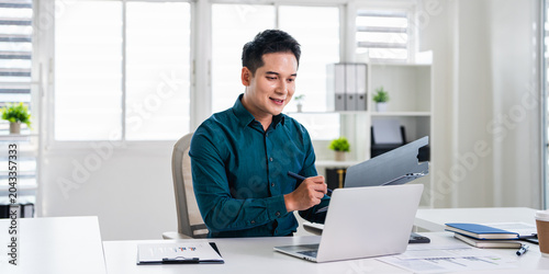 A businessman is working in modern office, reviewing documents . Focused and professional.