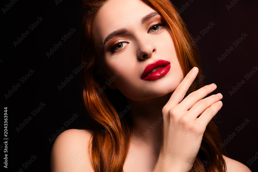 Fototapeta premium Stunning young woman with vibrant red hair posing in elegant lighting showcasing natural beauty and captivating allure