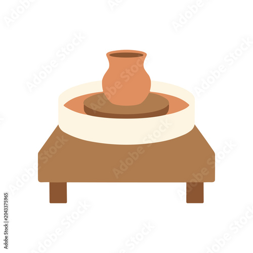 Pottery wheel with clay vase.