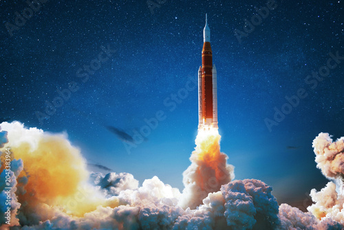 powerful space rocket launches into the starry night sky, massive clouds of smoke and fire. inspiring concept of space exploration, modern science, future cosmos travel. Spaceship lift off, creative