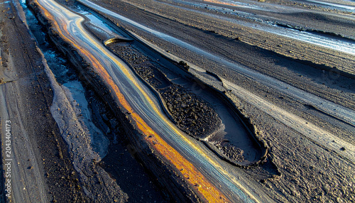 Extreme close up of a tar road surface melting in peak summer heat