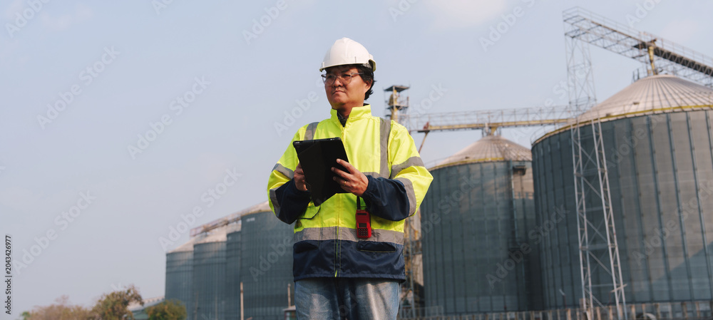 Fototapeta premium Technicians are inspecting the operational systems of the fresh food processing plant structure.