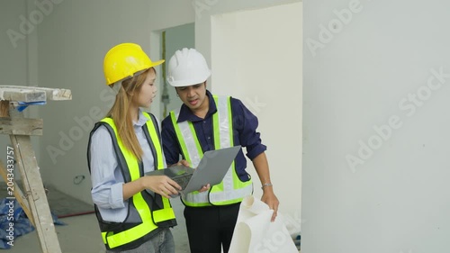 Construction worker safety helmet, safety vest, laptop, blueprint, engineer, site inspection project planning teamwork indoor construction site interior renovation work workplace plan, worker, laptop