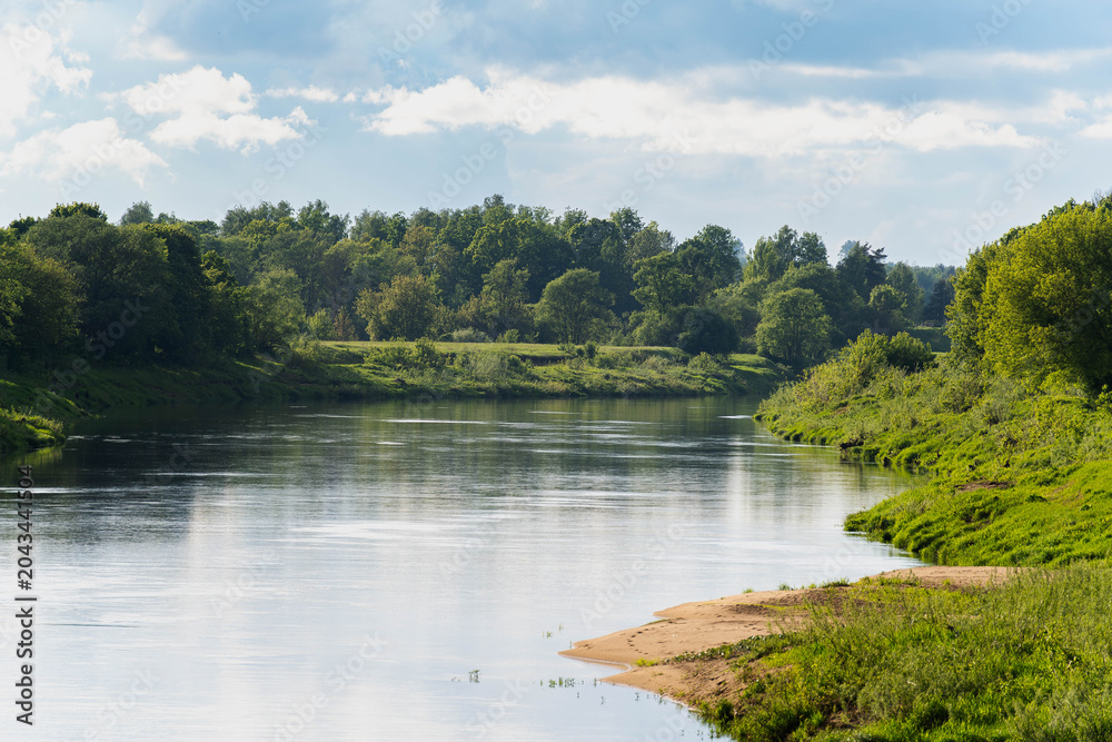 Obraz premium Calm Daugava River with green banks in Latvia