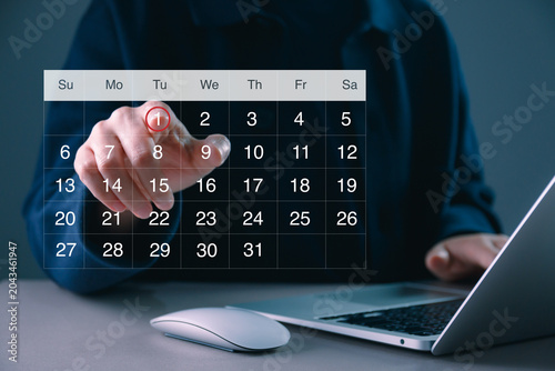 Digital calendar scheduling concept with hand selecting date on virtual interface, time management, appointment planning, business organization, deadline tracking, and productivity workflow system.
