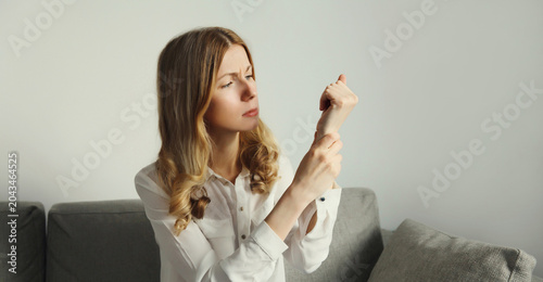 Tableau sur toile Unhealthy young woman suffers from wrist pain, tunnel syndrome, unwell girl touc