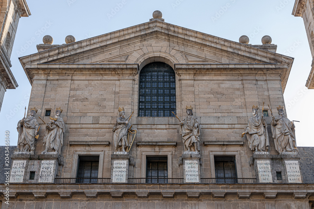 Fototapeta premium San Lorenzo de El Escorial, Spain. Six statues of Kings of Judah by Juan Bautista Monegro on the basilica facade, with Latin inscriptions below each figure. Built 1563-1584