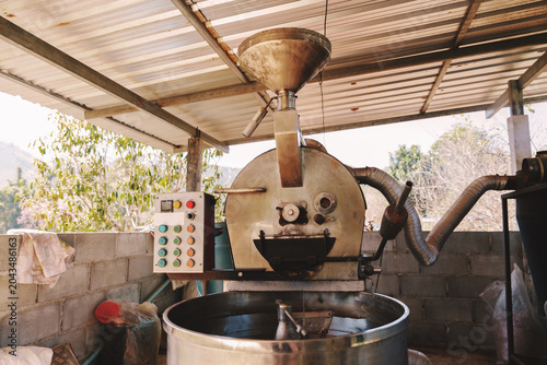 Bild auf Leinwand The coffee beans are being roasted in the machine, ready for the next step in the process
