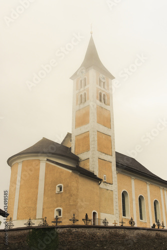 Church in the mist. Alpine village Ladis, Austria