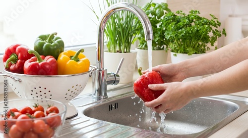 Washing vegetables in a kitchen sink