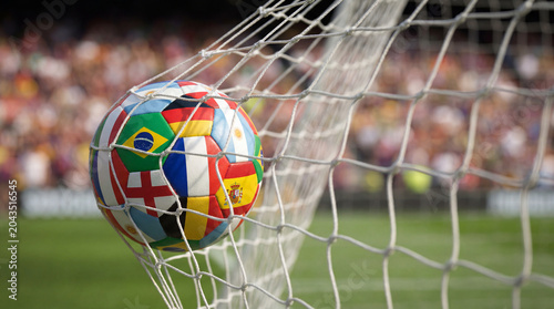 Football and World Cup Concept soccer ball hitting goal net in stadium Audience 