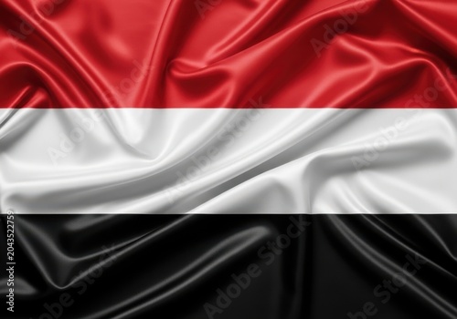 The national flag of yemen with a silky, rippled texture