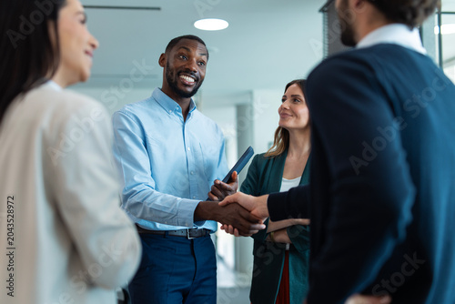 Business partners shaking hands making deal in office