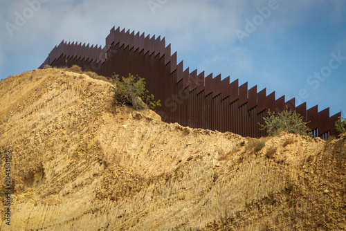 Fotografija Looking up at the international boarder wall from Tijuana Mexico