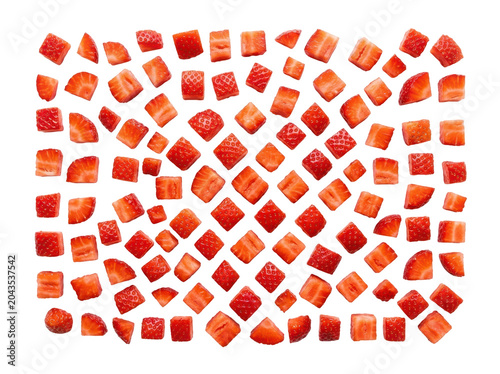 Scattered fresh strawberry pieces arranged in a dynamic pattern on a white background