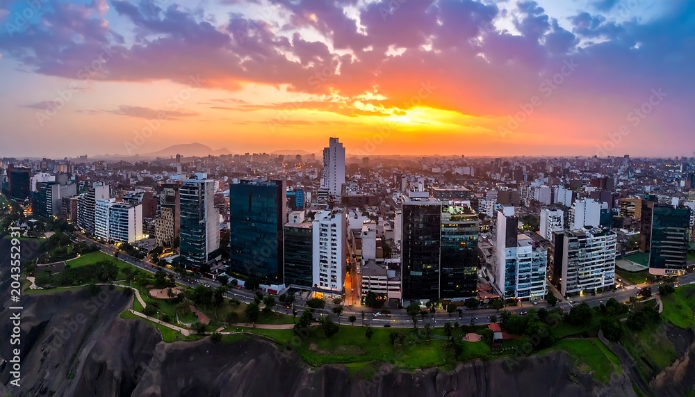 Obraz premium Vibrant Urban Skyline Glowing at Sunset Above Coastal Cliffs