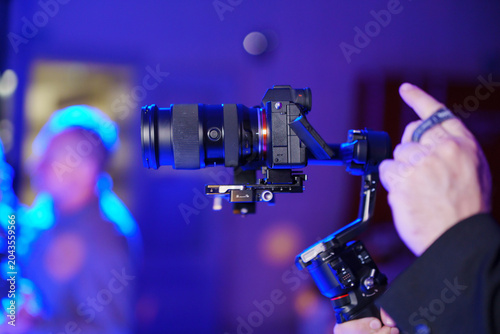Hand using professional camera gimbal stabilizer