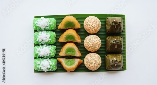 Indonesian jajanan pasar flat lay, traditional klepon dadar gulung onde-onde snacks overhead