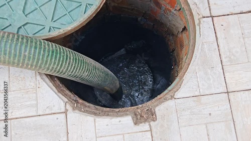Septic tank. Pipe in a drainage pit. Pumping wastewater from a septic tank. Septic tank maintenance. Sewage pumping machine.