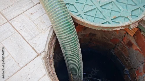 Septic tank. Pipe in a drainage pit. Pumping wastewater from a septic tank.